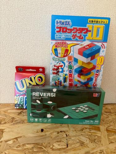a stack of lego games and a box on a table at MINI HOTEL totonoi ロウリュ式サウナのある静かな平屋 in Shimonoseki