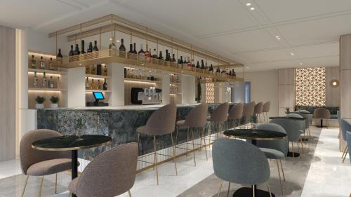 a bar with a row of chairs and tables at SH Jávea in Jávea