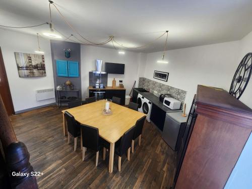 a kitchen and dining room with a table and chairs at Renovated House with 4 Private Suites in Saint-Germain