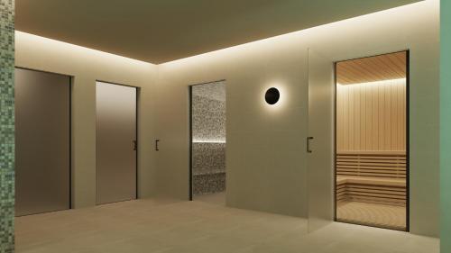 a hallway with glass doors and a walk in shower at SH Jávea in Jávea