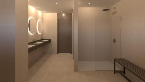 a bathroom with two sinks and a walk in shower at SH Jávea in Jávea