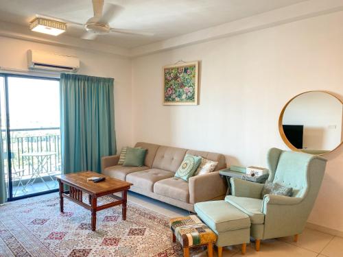a living room with a couch and a table at Cozy Emira Home 3 Bedrooms in Shah Alam