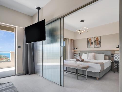 a bedroom with a bed and a sliding glass door at Creta Star Hotel - Adults Only in Skaleta
