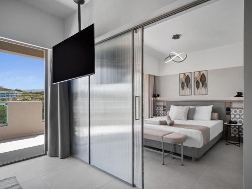 a bedroom with a bed and a sliding glass door at Creta Star Hotel - Adults Only in Skaleta