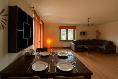 a living room with a table with plates and wine glasses at Sweet home 55 in the heart of Dilijan in Dilijan