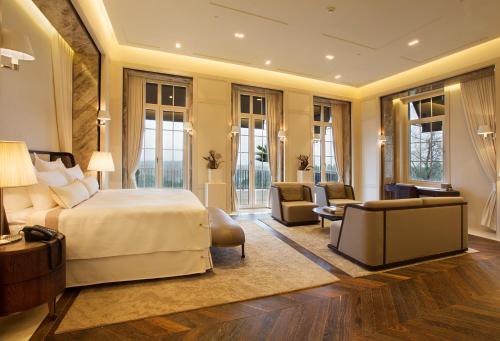 a bedroom with a bed and a living room at Kemer Country Hotel İstanbul in Istanbul