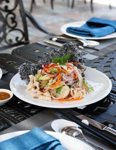 a white plate of food on a table at Wonderland Royal Mansions Ho Tram in Xuyên Mộc