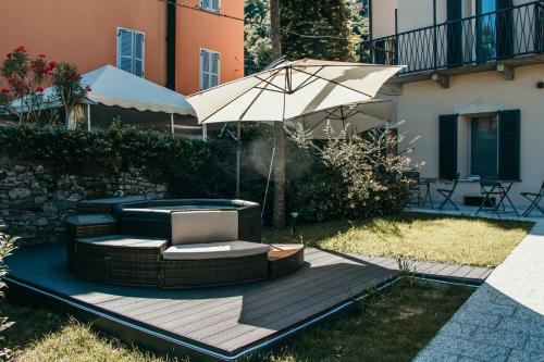 a patio with a chair and an umbrella at Gio Leo Guest House in Lesa