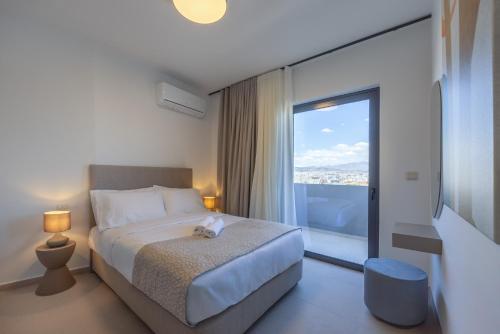 a bedroom with a bed and a large window at Sokio Attiki Hotel, BW Premier Collection in Athens