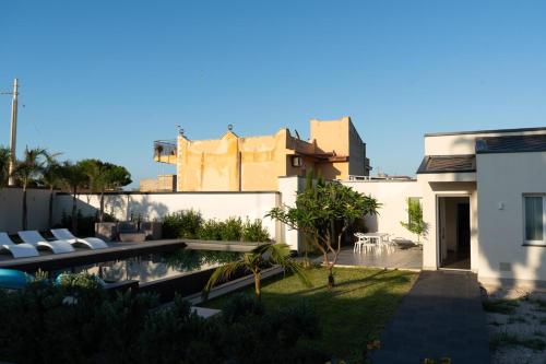 a view of the backyard of a house with a swimming pool at Hotel La Martinica in Ficarazzi