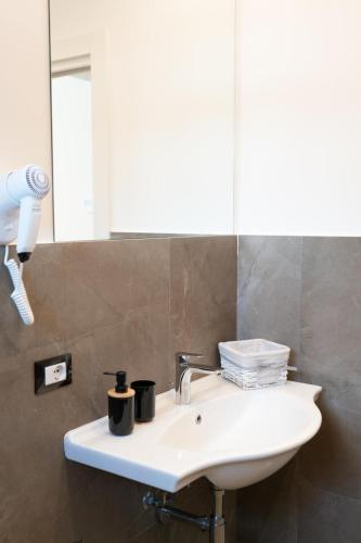a bathroom with a sink and a mirror at Hotel La Martinica in Ficarazzi