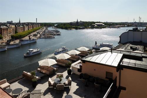 a view of a river with boats in the water at Radisson Collection, Strand Hotel, Stockholm in Stockholm