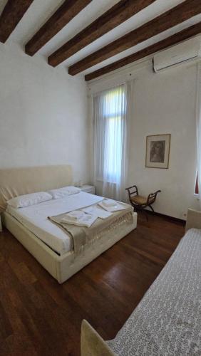 a bedroom with a large bed and a window at Ca' Amore Venezia in Venice