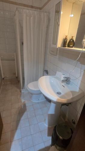 a bathroom with a white sink and a toilet at Ca' Amore Venezia in Venice