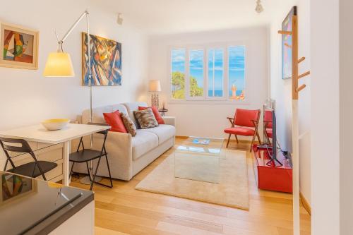a living room with a couch and a table at Comfortable 1-Bedroom Apartment Near Monaco in Roquebrune-Cap-Martin