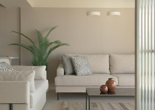 a living room with a couch and a table at Creta Star Hotel - Adults Only in Skaleta