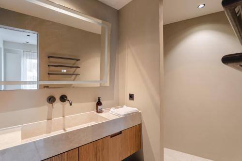 a bathroom with a sink and a mirror at Moon Light - A 50m de la mer in Dinard
