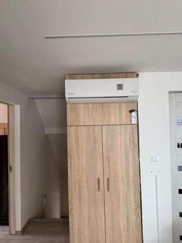 a room with a cabinet and a ceiling at Sóstó Suites in Nyíregyháza