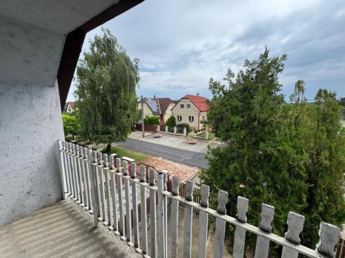 a view from the balcony of a house with a fence at Sóstó Suites in Nyíregyháza