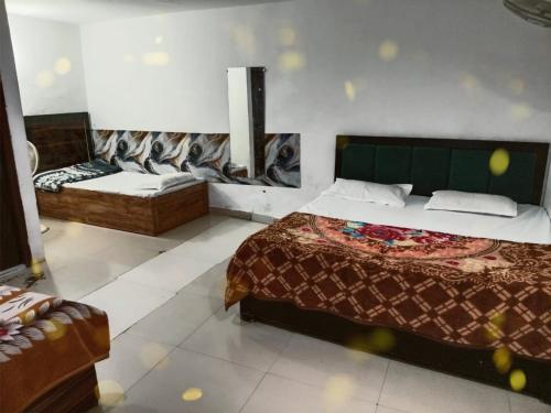 a bedroom with a bed and a couch in it at Mohit guest In in Vrindāvan