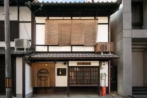 a building with a sign on the side of it at 禅 御所西邸 in Kyoto
