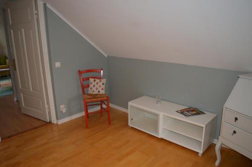 a room with a chair and a table with a chair at Humlebo in Boda Glasbruk