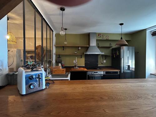 a kitchen with a table with a radio on the counter at La Maison du Marinier in Crouzilles