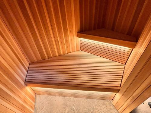 a small sauna with wooden walls and wooden floors at MINI HOTEL totonoi ロウリュ式サウナのある静かな平屋 in Shimonoseki