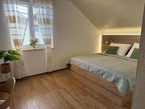 a bedroom with a bed and a window at Penzion 666 Slavonice in Slavonice