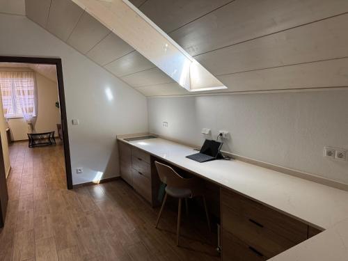 an office with a desk with a laptop on it at Penzion 666 Slavonice in Slavonice