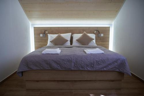 a bedroom with a bed with two towels on it at Penzion 666 Slavonice in Slavonice