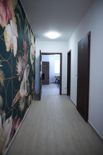 a hallway with a mural of flowers on the wall at Penzion 666 Slavonice in Slavonice