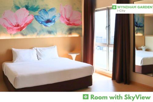 a bedroom with a bed and a room with sky view at Wyndham Garden i-City Shah Alam in Shah Alam