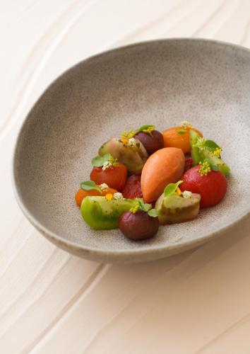 a bowl filled with vegetables on top of a table at Villa Miraé by Inwood Hotels - Cap d'Antibes in Antibes