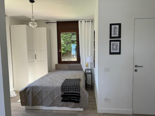 a bedroom with a bed and a window at Marta in Stresa