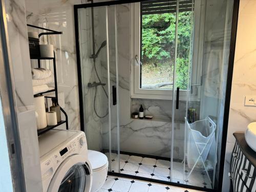 a bathroom with a shower and a washing machine at Marta in Stresa