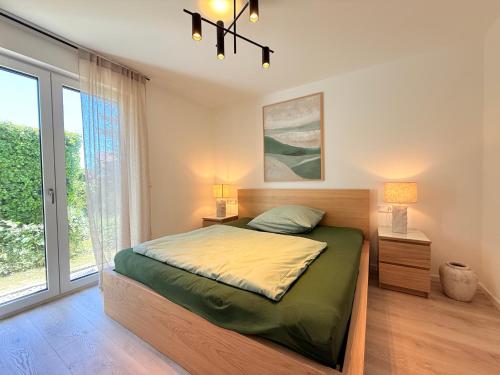 a bedroom with a bed and a large window at Suite Carpe Diem in Uhldingen-Mühlhofen