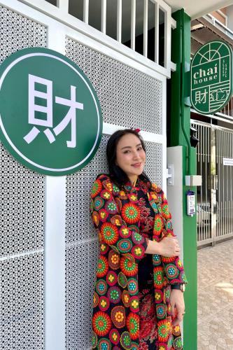 a woman is standing in front of a sign at 財家 Chai House NEAR Lee Garden,Private parking in Hat Yai