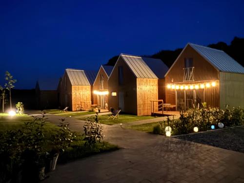 a row of houses at night with lights at Morska 2K in Łukęcin