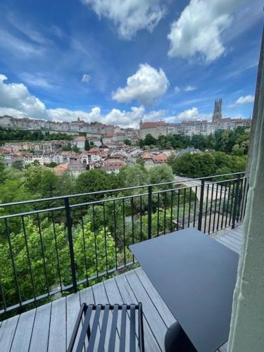 a balcony with a table and a view of a city at La Sauvage in Fribourg