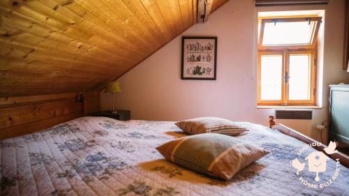 a bedroom with a bed with two pillows on it at Holiday Home Elizabeth in Svojek