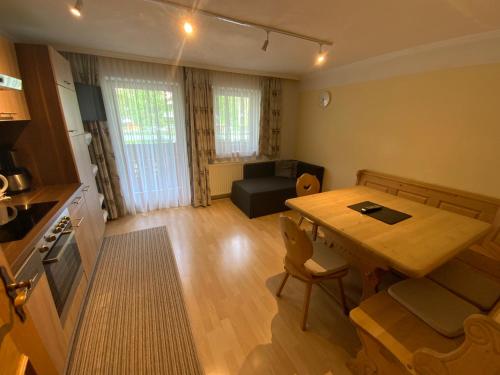 a kitchen and living room with a table and a couch at Haus Praxmarer in Kaunertal