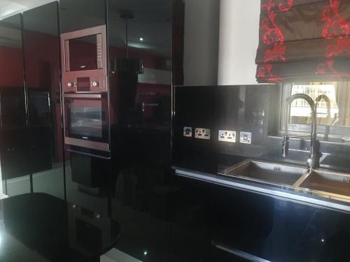 a kitchen with a sink and a counter top at Modern, stylish & comfortable 3 bedroom apartment with jacuzzi and private yard with barbeque in Mellieħa