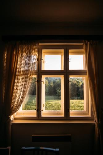 a window with a view of a field of grass at Holiday Home Elizabeth in Svojek