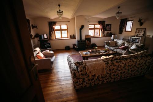a living room with two couches and a table at Holiday Home Elizabeth in Svojek