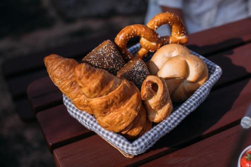 a basket of croissants and pretzels on a table at Holiday Home Elizabeth in Svojek