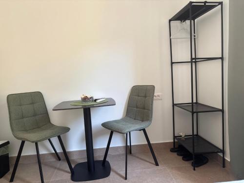 two chairs and a table in a room at STR Apartments in Tivat