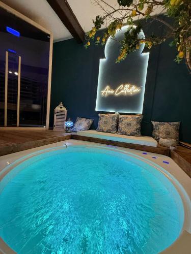 a large swimming pool in a room with a sign at AMA Esclusive SPA Ariosto in Ferrara