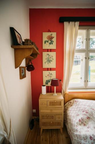 a bedroom with red walls and a bed and a window at Holiday Home Elizabeth in Svojek
