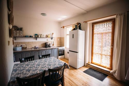 a kitchen with a table and a white refrigerator at Holiday Home Elizabeth in Svojek